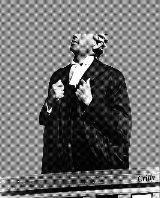 Black and white image of a person in a formal robe, adjusting their collar against a gray background.